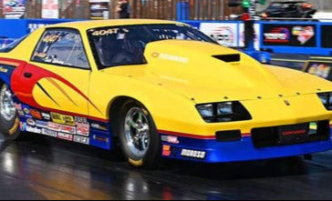 Yellow Iroc Camaro race car with red and blue accents on a track